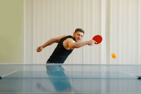 Man with  racket plays the ball off