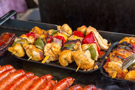 Fresh meat with vegetables on skewers in metal tray, dining room. Hotel cuisine, traditional...
