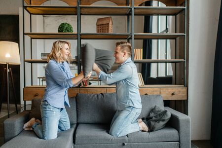 Funny love couple staged fights on the pillows