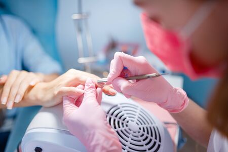 Cosmetology salon, manicure, manicurist and womanの写真素材