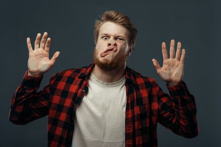 Mans crazy face crushed on transparent glass
