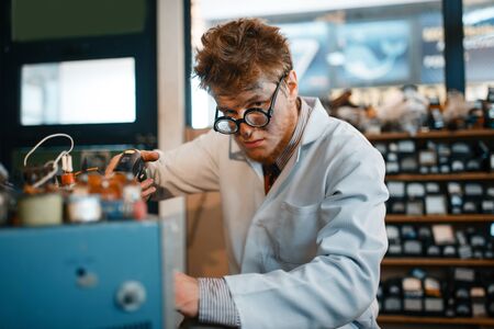 Strange scientist holds screwdriver at his templeの写真素材
