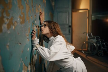 Female patient in strait jacket, insanityの写真素材
