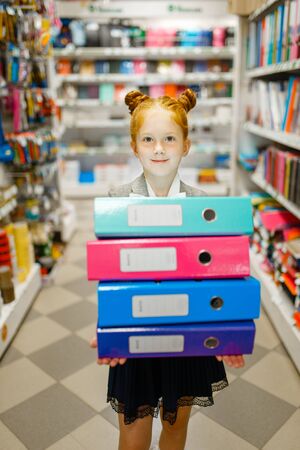 School girl holds folders in stationery storeの写真素材