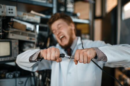 Engineer connects wires under tension in labの写真素材