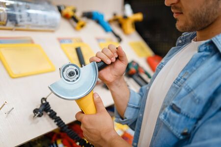 Buyer holding edging machine in hardware storeの写真素材