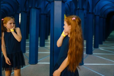 Scared little girlfriends playing in labyrinthの写真素材