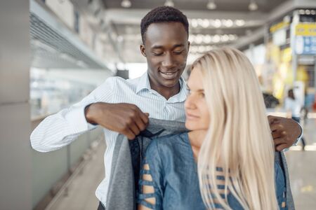Businessman takes care of a lady in car dealershipの写真素材