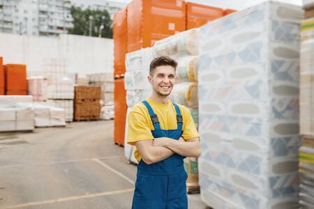 Male builder at the pallets of insulation material