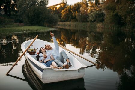 Love couple lying in a boat and dreamingの写真素材