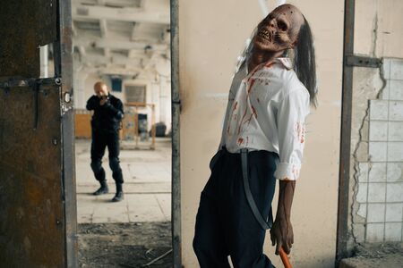 Man with gun fights with undead zombie, nightmareの写真素材