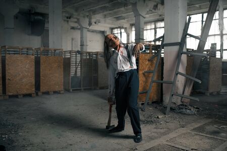 Zombie man, undead human in abandoned factory