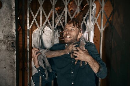 Man running away from zombie army, apocalypseの写真素材