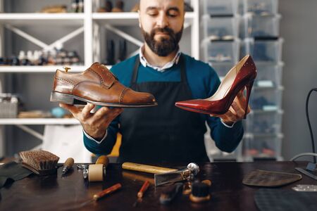 Bootmaker shows repaired shoes, footwear repairの写真素材