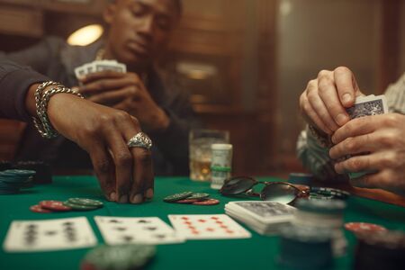Two poker players place bets in casinoの写真素材