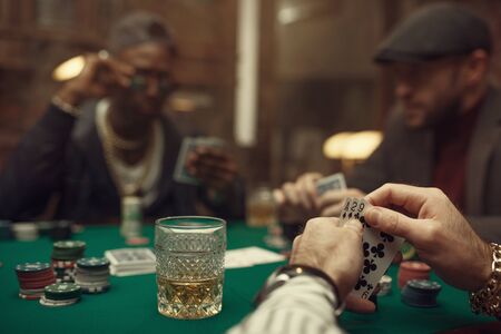 Two poker players with cards in casinoの写真素材