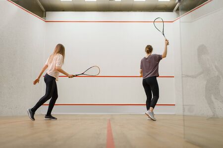 Two female players with rackets, squash gameの写真素材