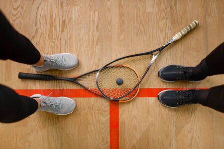 Female players legs and squash rackets, top viewの写真素材