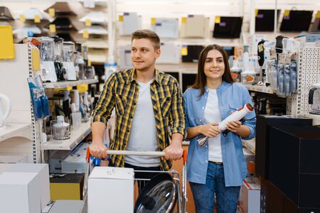 Couple holds electric blender in electronics storeの写真素材