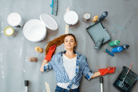 Female house painter lies on the floor, top viewの写真素材