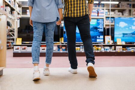 Couple choosing TV in electronics storeの写真素材