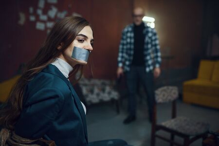 Maniac kidnapper and victim with taped mouth shut