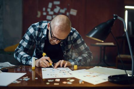 Maniac kidnapper hands cuts out lettersの写真素材