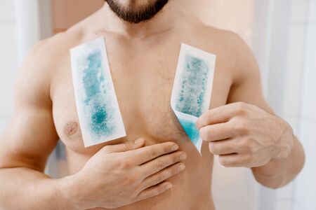 Screaming man removes chest hair, depilationの写真素材