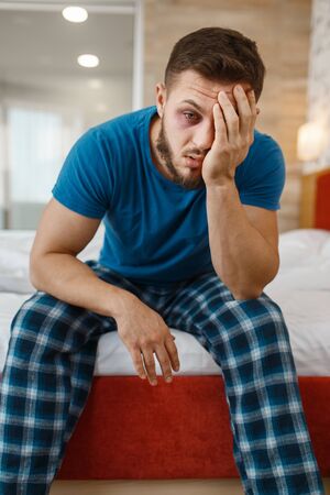 Tired man awake in bedの写真素材