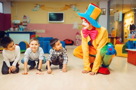 Clown animator play with group of little boysの写真素材