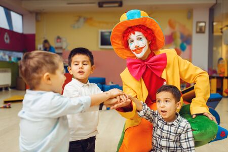 Funny clown and little boys play counting gameの写真素材