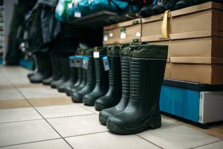 Row of rubber boots in fishing shop, nobodyの写真素材