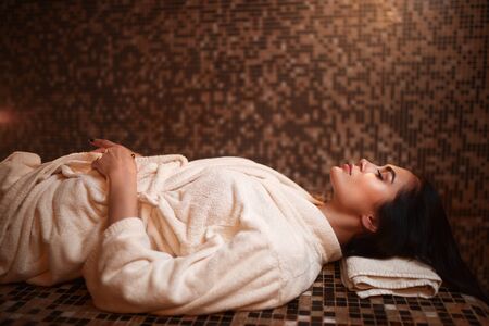 Woman lying on a hot stone, turkish hamam, saunaの写真素材