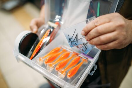 Angler holds box with hooks and baublesの写真素材
