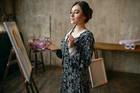 Female painter poses in art studioの写真素材