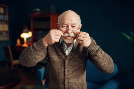Cheerful elderly man shows his moustach