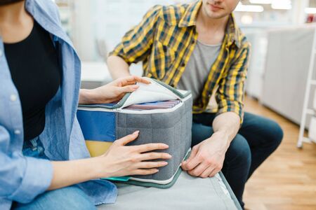 Couple choosing mattress core in furniture shopの写真素材