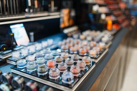 Production assortment on showcase in cosmetics store, nobody. Luxury beauty shop, shelf with products in fashion marketの写真素材