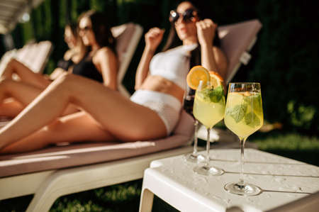 Fresh coctails, women leisures on backgroundの写真素材