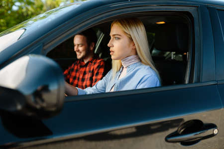 Student and male instructor in car, driving schoolの写真素材
