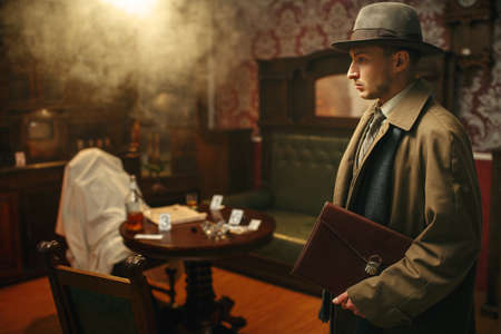 Puzzled detective in coat and hat, crime sceneの写真素材