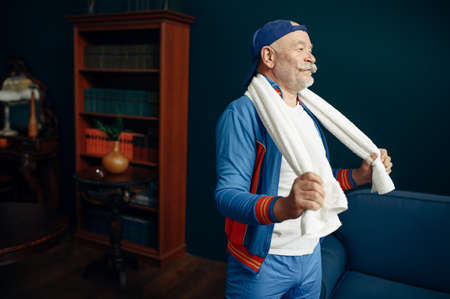 Tired elderly sportsman in uniform after workout