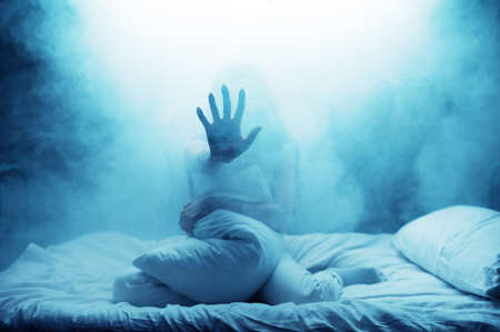 Psycho woman show hand in bed, psychedelic personの写真素材