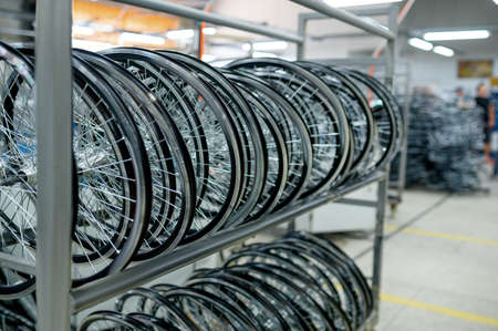 Row of new aluminum bicycle wheels on the shelfの写真素材