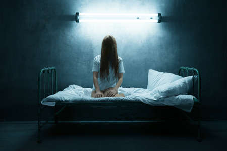 Psycho woman screams in bed, insomnia horrorの写真素材