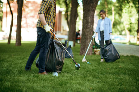 Two men collects plastic garbage, volunteeringの写真素材
