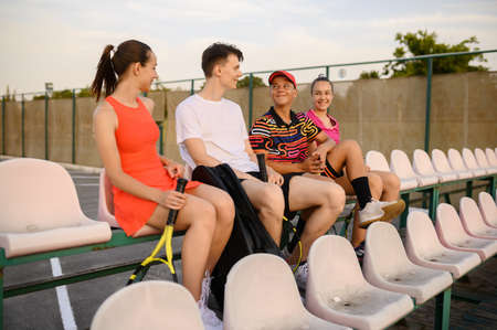 Mixed doubles tennis players are resting on podiumの写真素材