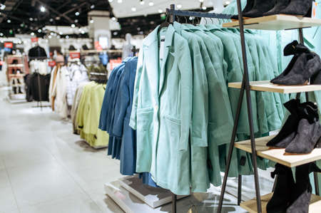Clothes, coats on racks in clothing store, nobodyの写真素材