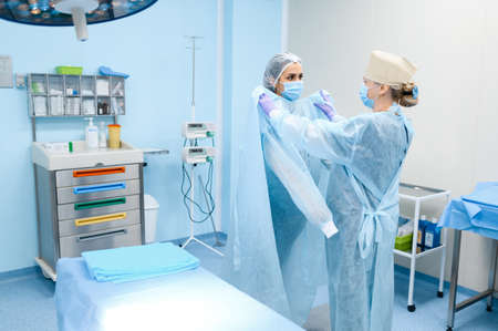 Female surgeon and assistant in operating roomの写真素材
