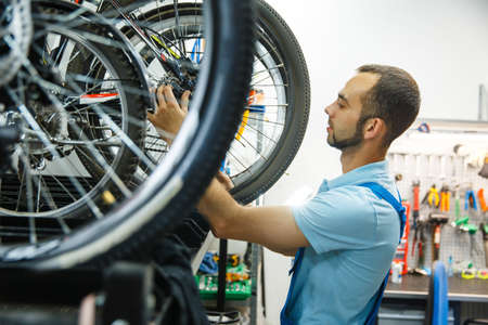 Bicycle workshop, man finished assembling